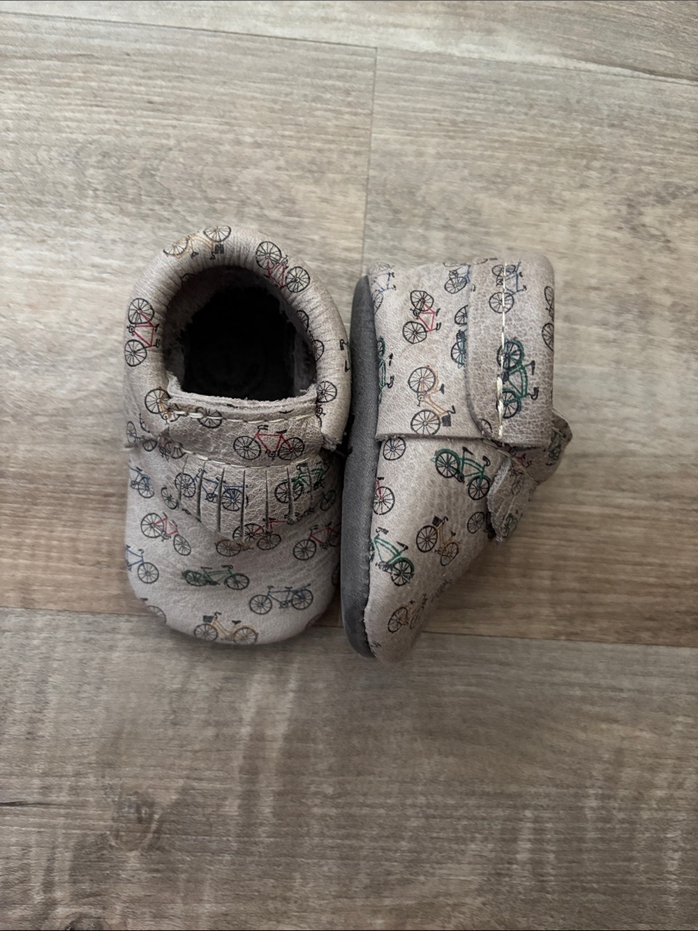 Freshly Picked Beige Baby Moccasins with Multicolor Bicycle Print
